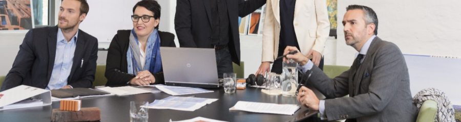Architect presenting a virtual reality presentation to business people in a meeting room