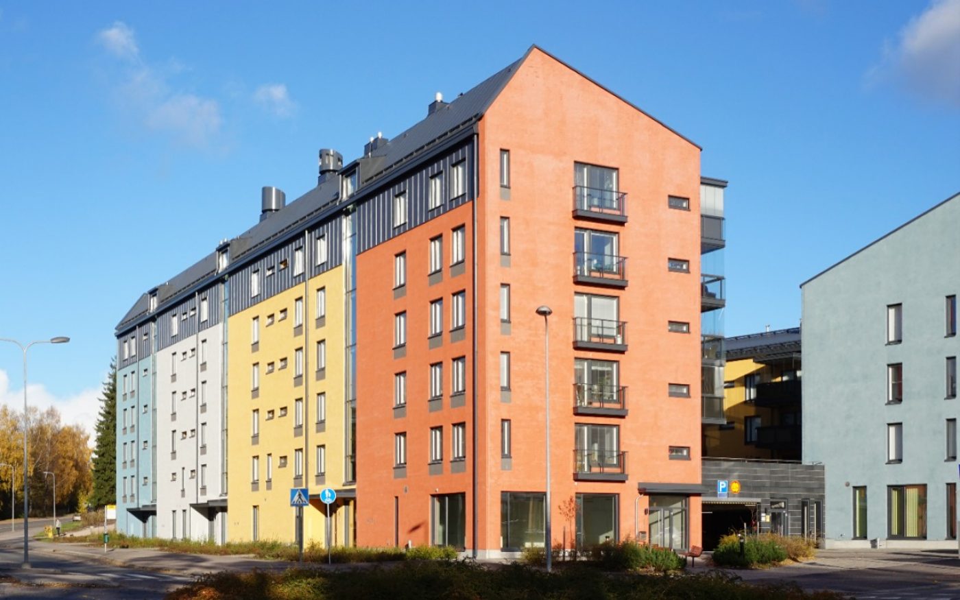 Building with light plastering over brick facade