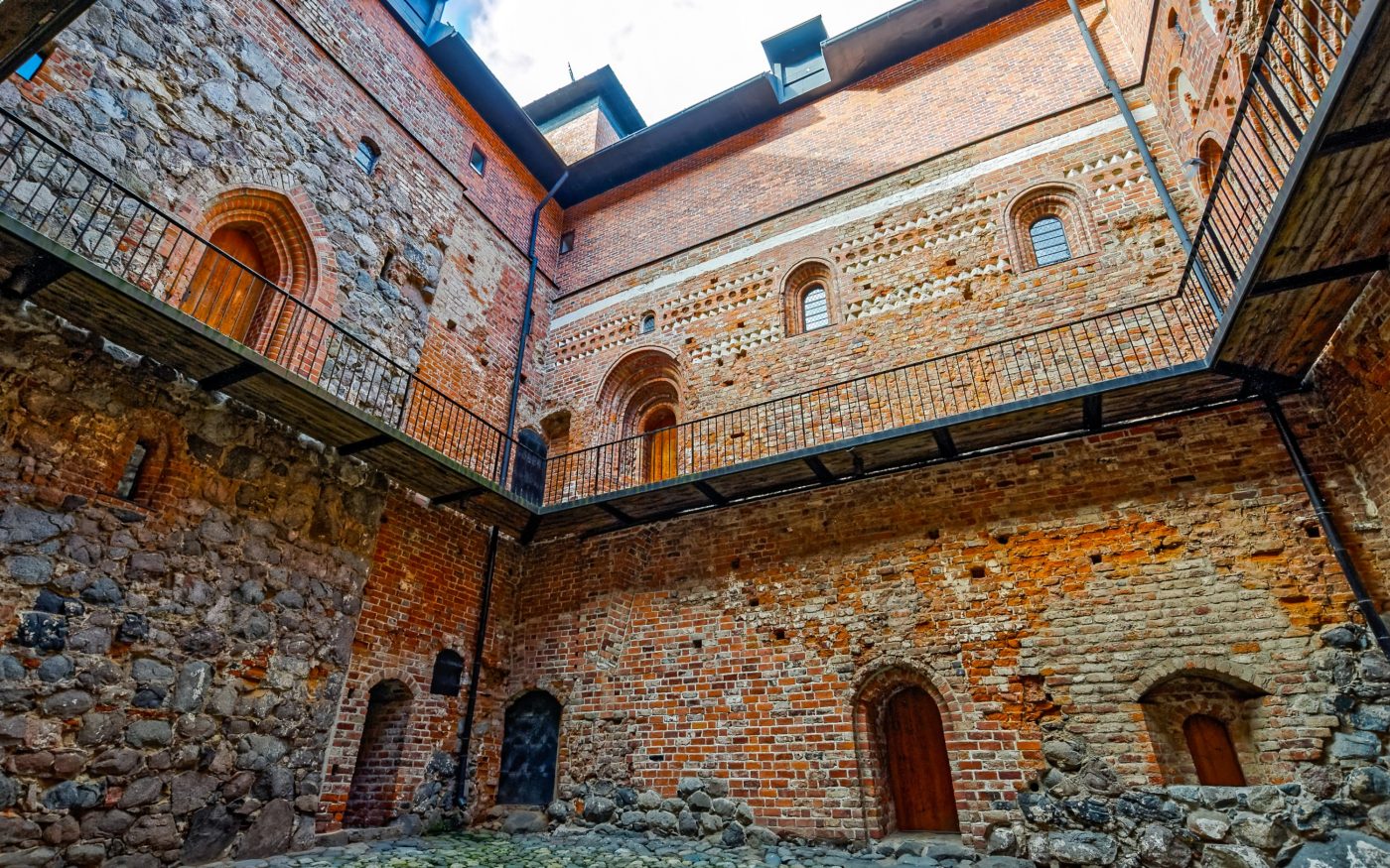 Inner yard of medieval castle with  stone and brick masonry wall