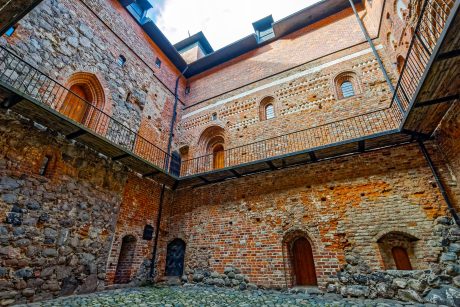 Inner yard of medieval castle with  stone and brick masonry wall
